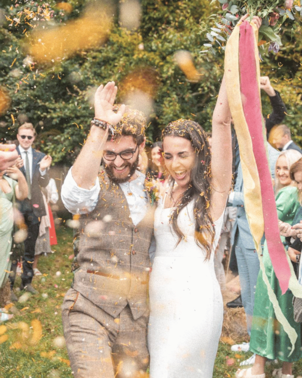 wedding couple being showered with confetti