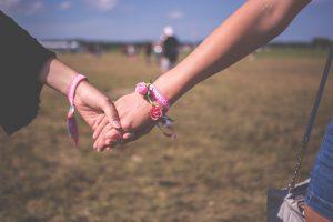 couple holding hands at festival
