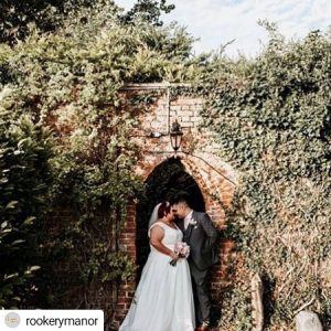 couple kissing under brick arch