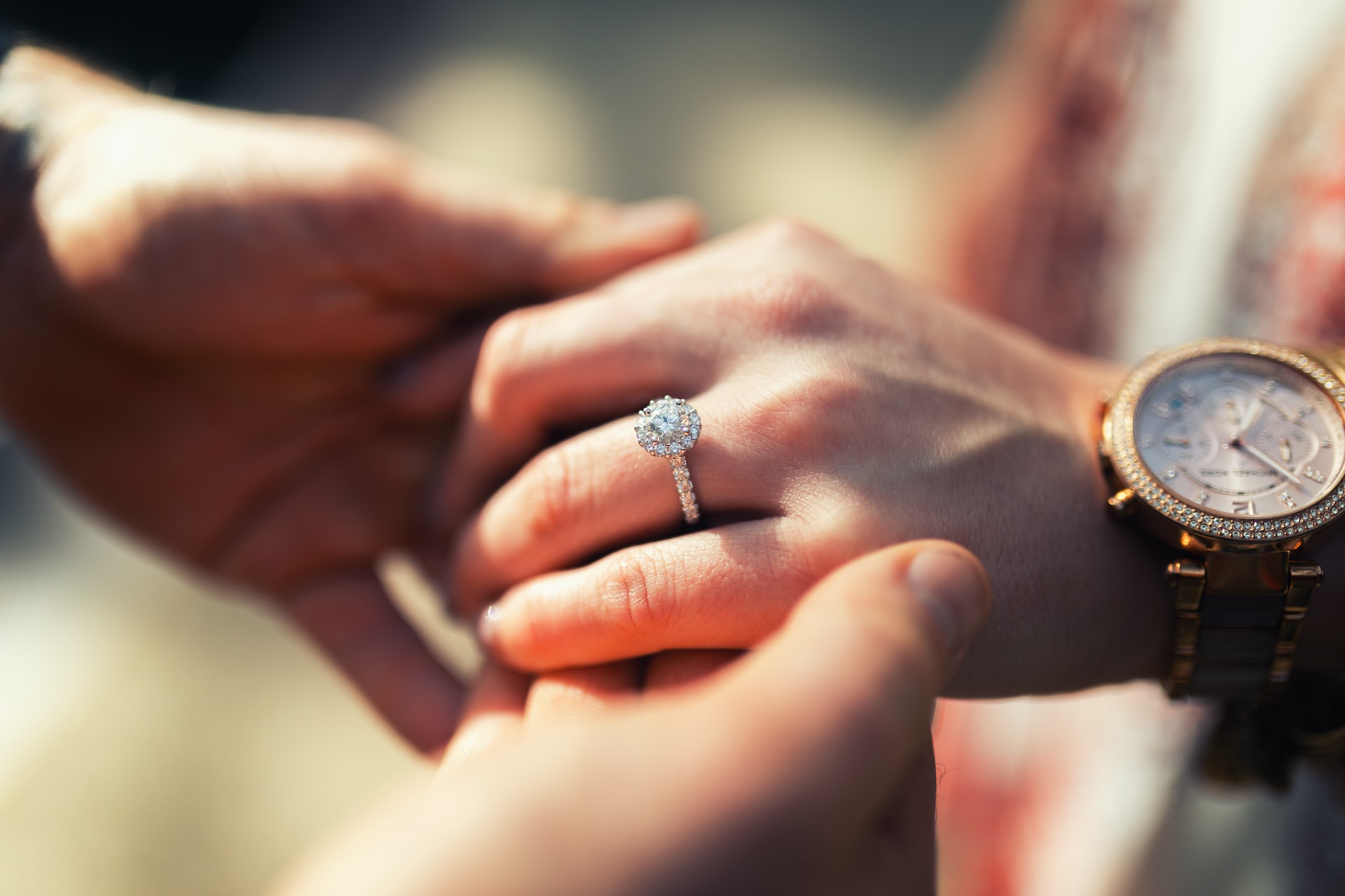 two people holding hands with a diamond engagement ring 